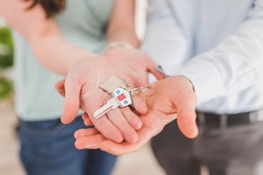 pexels-photo-8293771-8293771 Close-up of a couple holding keys, symbolizing homeownership and investment.