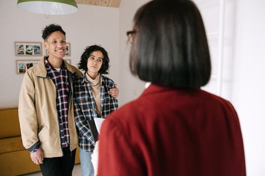 pexels-photo-8962689-8962689 Young couple discussing real estate options with an agent indoors, highlighting home buying process.